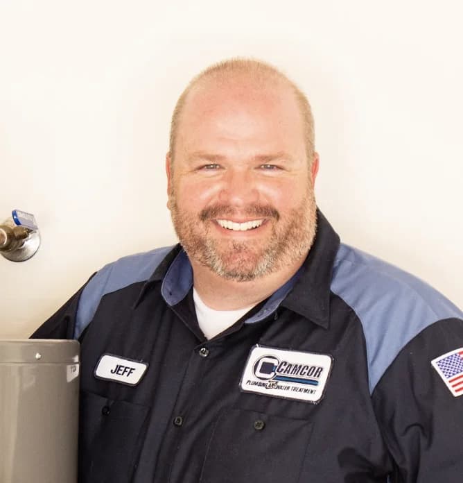 Jeff, owner of Camcor Plumbing, smiling in a Camcor work shirt