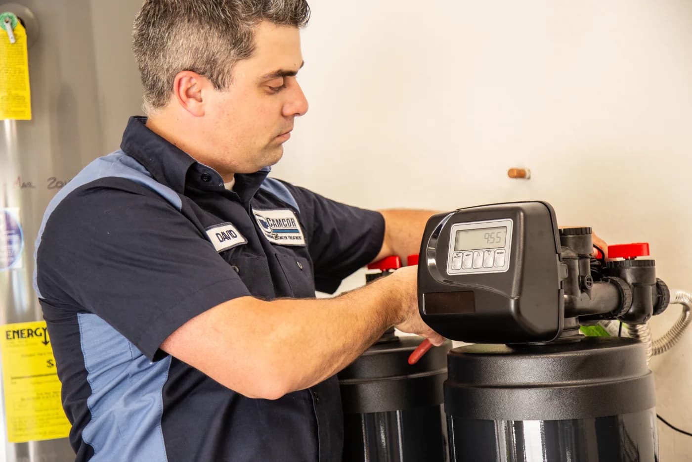 Camcor technician installing a water softener
