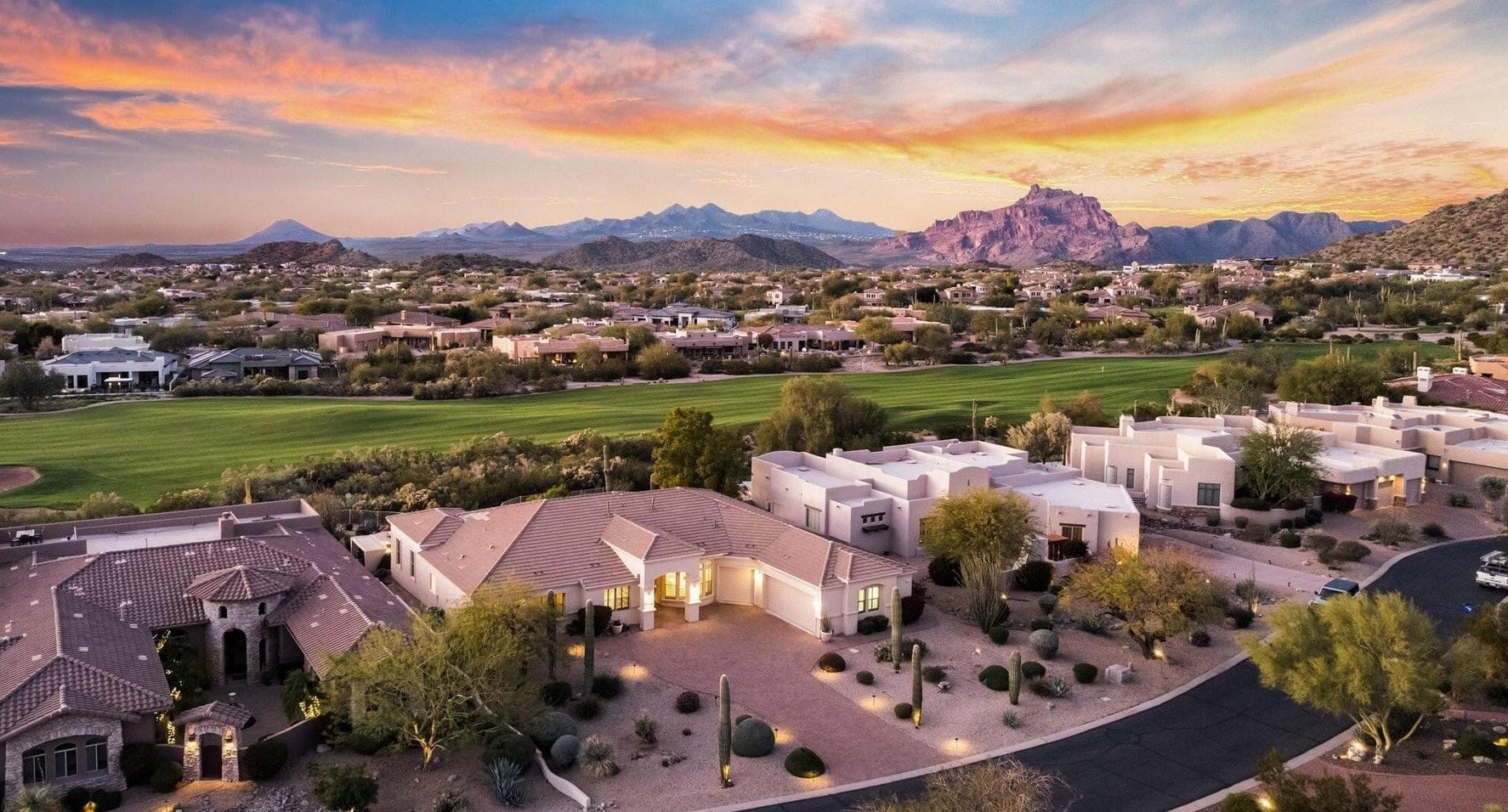 Aerial view of Las Sendas homes and golf course at sunset with Red Mountain behind, Northeast Mesa, Arizona
