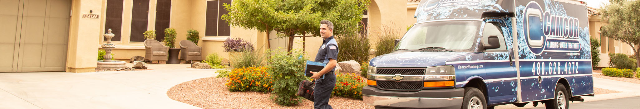 Camcor van and technician in front of house.