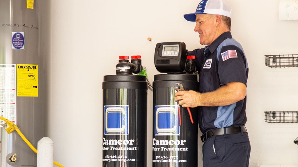 Technician maintaining a reverse osmosis unit-.