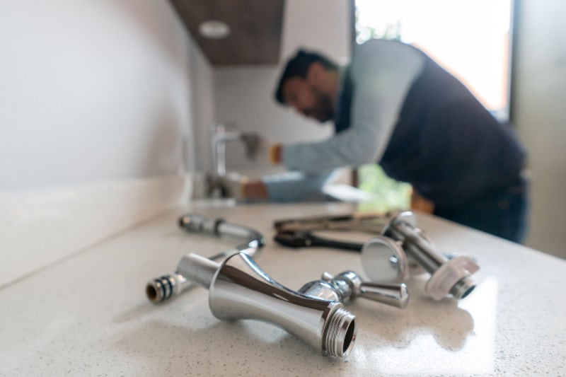 Man fixing a faucet.