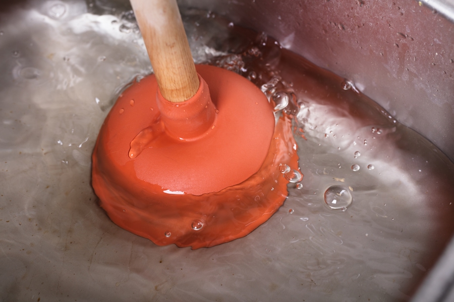 Plunger trying to unclog a sink.